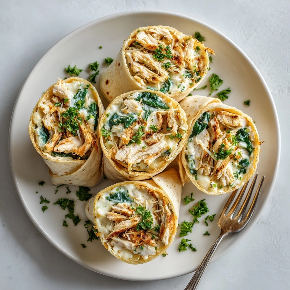 Golden, pan-seared Comfort Food Chicken Alfredo Wraps, boasting a delicious combo of soft tortilla and creamy goodness.