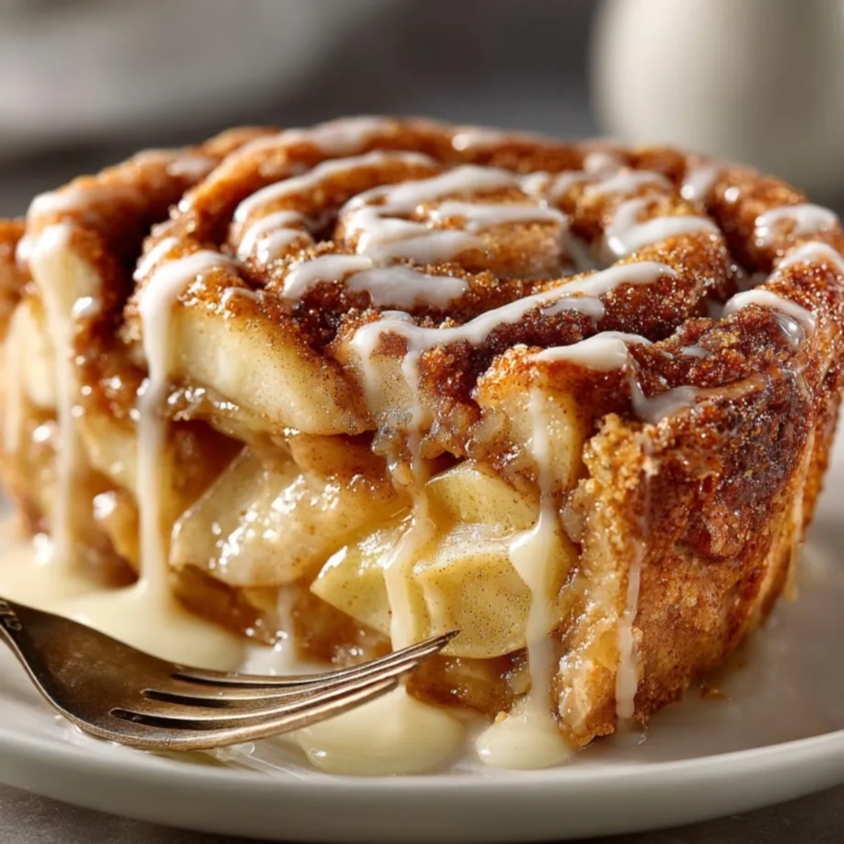 Cinnamon Roll Apple Pie: A warm, golden pie with bubbly apple filling and a sweet glaze drizzle.