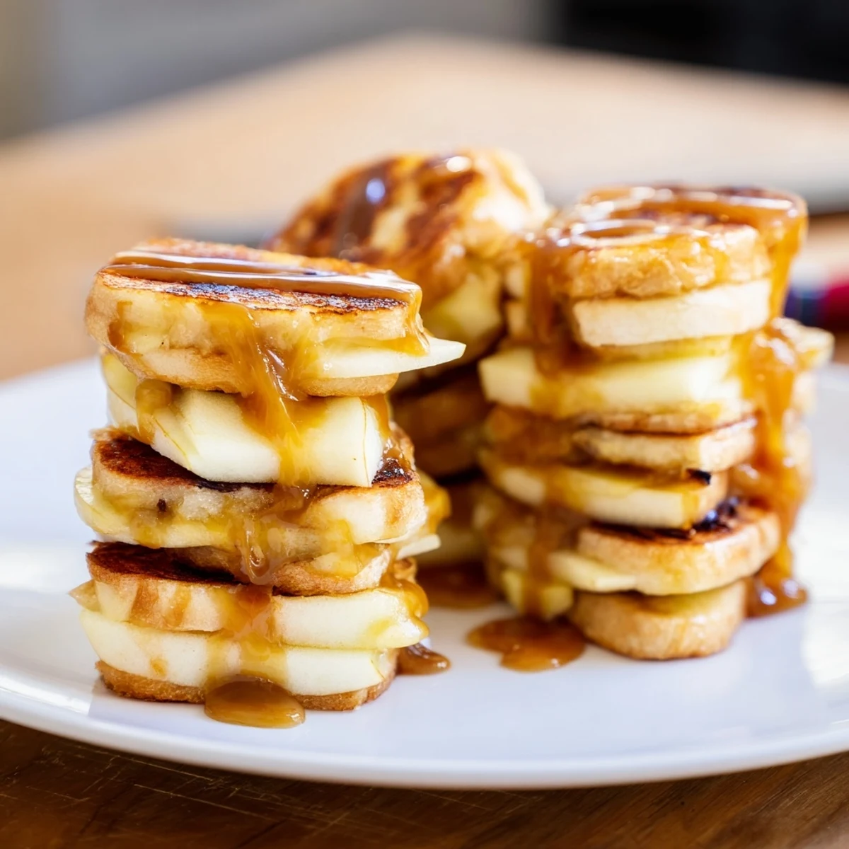 Mini grilled cheese bites filled with tart apples and rich caramel drizzle.  