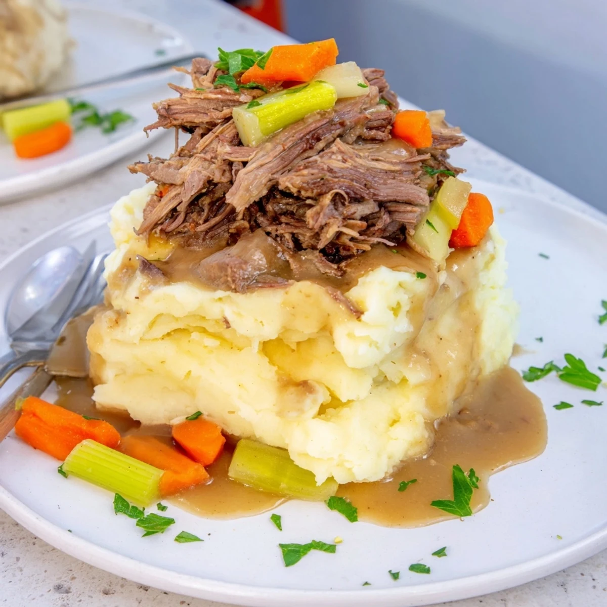 Tender Slow Cooker Pot Roast paired with creamy mashed potatoes, a comforting classic.  