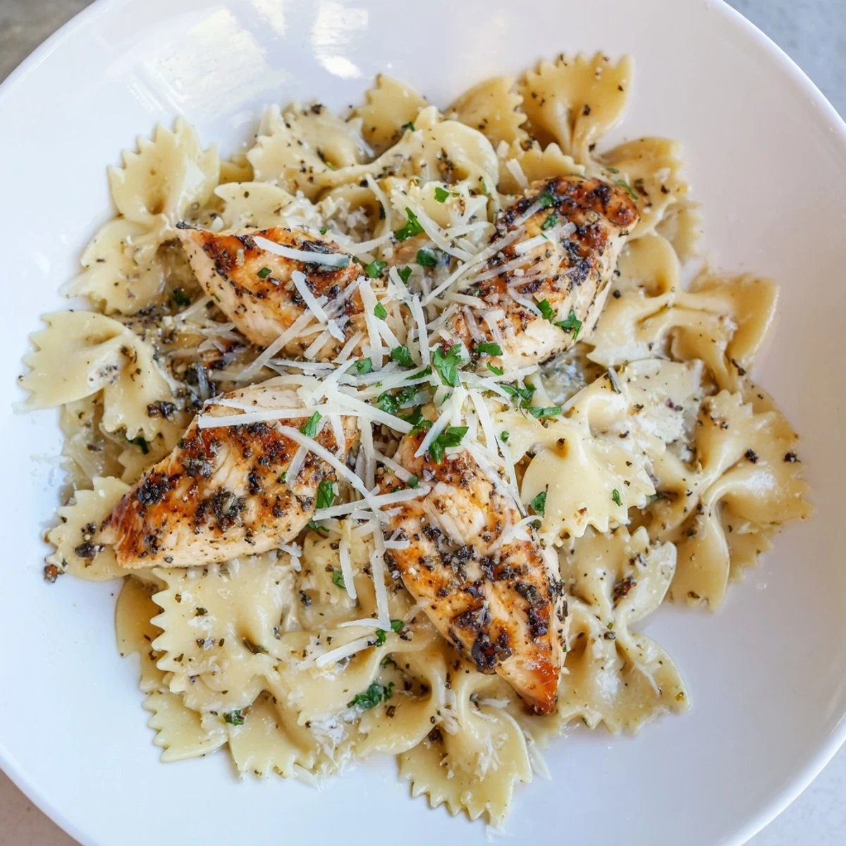 Golden chicken pieces and bowtie pasta coated in a delicious Mozzarella Garlic Butter sauce.