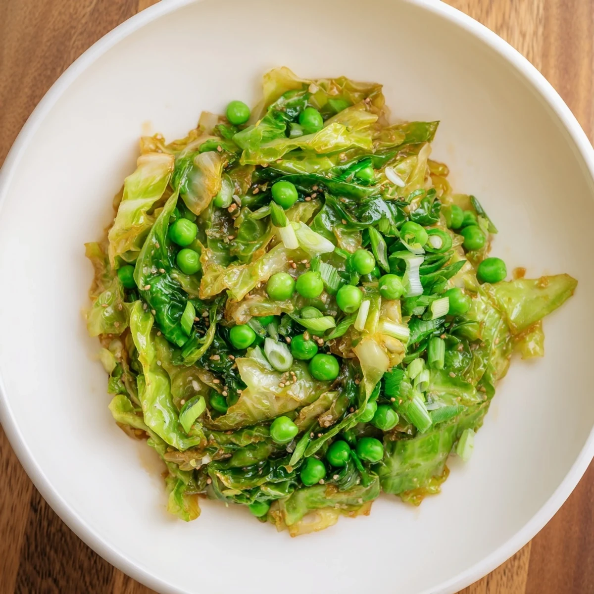 Savory Garlic Cabbage Stir-Fry, with tender-crisp cabbage and sweet peas, ready to serve over rice.