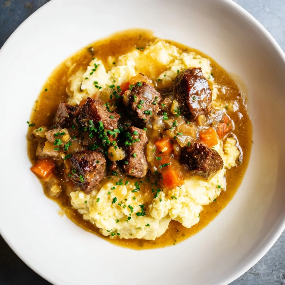 A close-up of Fall Apple Cider Stew Mash featuring flavorful beef in a rich, autumnal sauce and mashed potatoes.