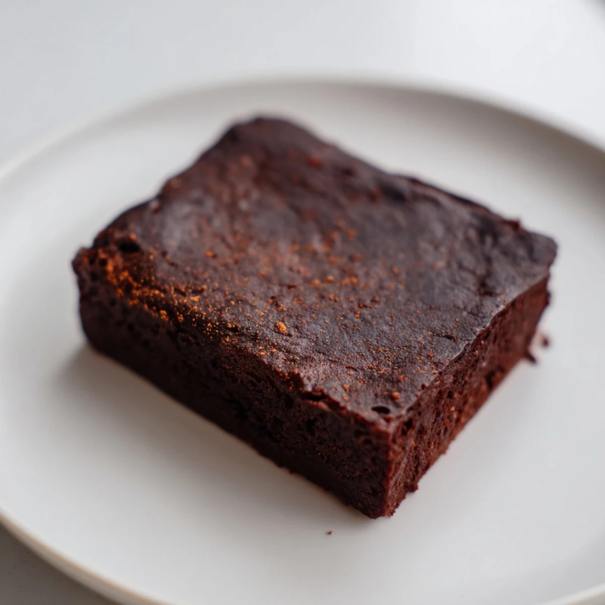 These decadent Pumpkin Workout Brownies look rich, dark, and perfectly cut, ready for a post-workout recovery snack.