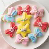 Star-shaped Pretty Bows cookies, delightfully decorated and ready to be enjoyed with an afternoon tea spread.