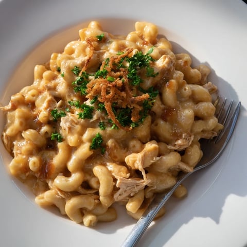 Creamy One-Pot Honey BBQ Chicken Mac and Cheese with melted cheese and herbs.  