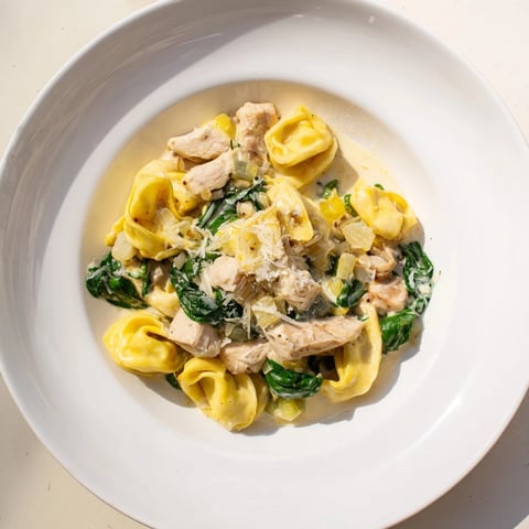 Creamy Chicken and Spinach Tortellini, a rich pasta dish with a creamy Parmesan sauce and tender chicken.