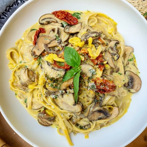 Plate of creamy Vegan Marry Me Mushroom Pasta, garnished with fresh basil for a delicious meal.