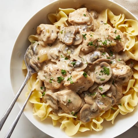 Delicious Creamy Chicken Stroganoff featuring sautéed mushrooms and a rich sauce.  