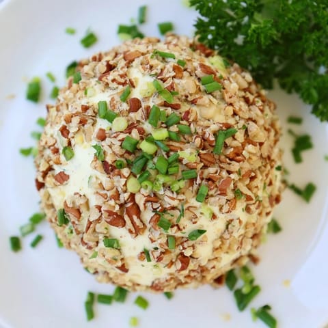 This homemade Classic Cheese Ball, with its ranch seasoning aromas, looks perfect for a party spread.