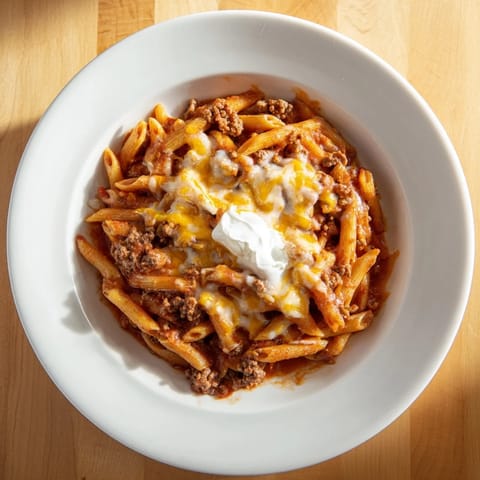 Easy Beef Enchilada Pasta, a one-pot meal, features bubbly cheese and flavorful ground beef.