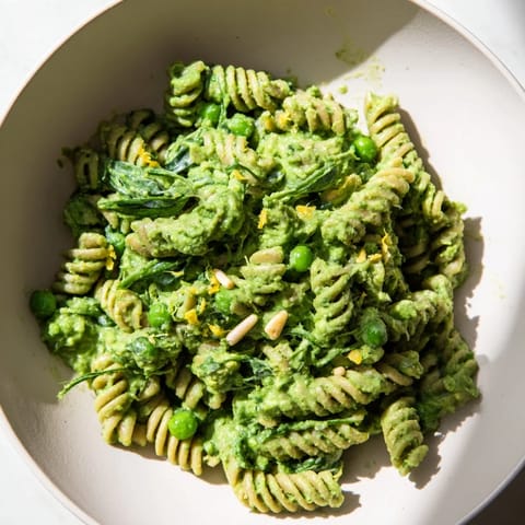 Close-up of the delicious Green Pea & Spinach Elf Green Protein Pasta, ready to be enjoyed with a lemon zest topping.