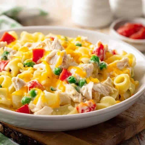 This Chicken Macaroni Southern Style features tender chicken and a rich, cheesy sauce with colorful veggies.