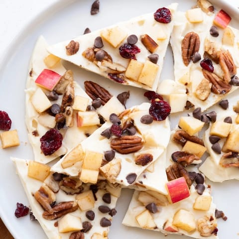 This frozen Apple Cinnamon Yogurt Bark reveals a colorful, healthy snack with fresh apple pieces.